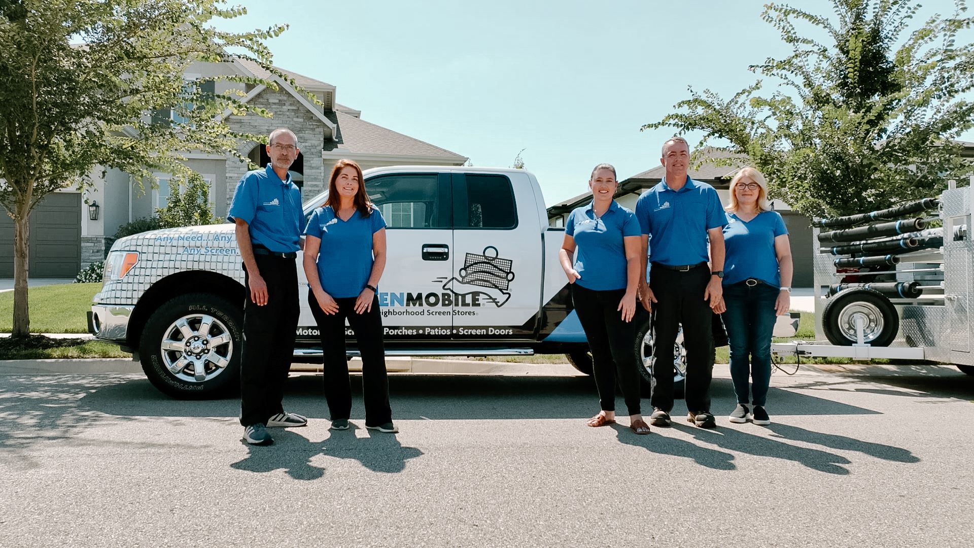 Screenmobile franchise team standing beside truck