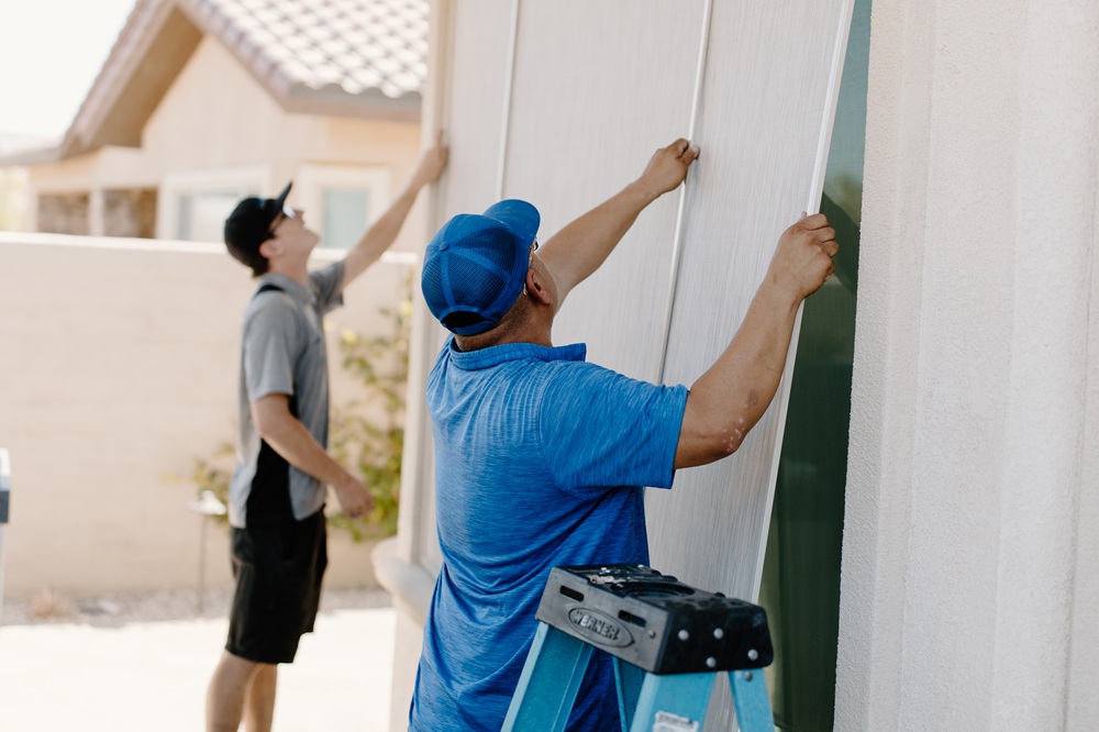 two men putting up a screen